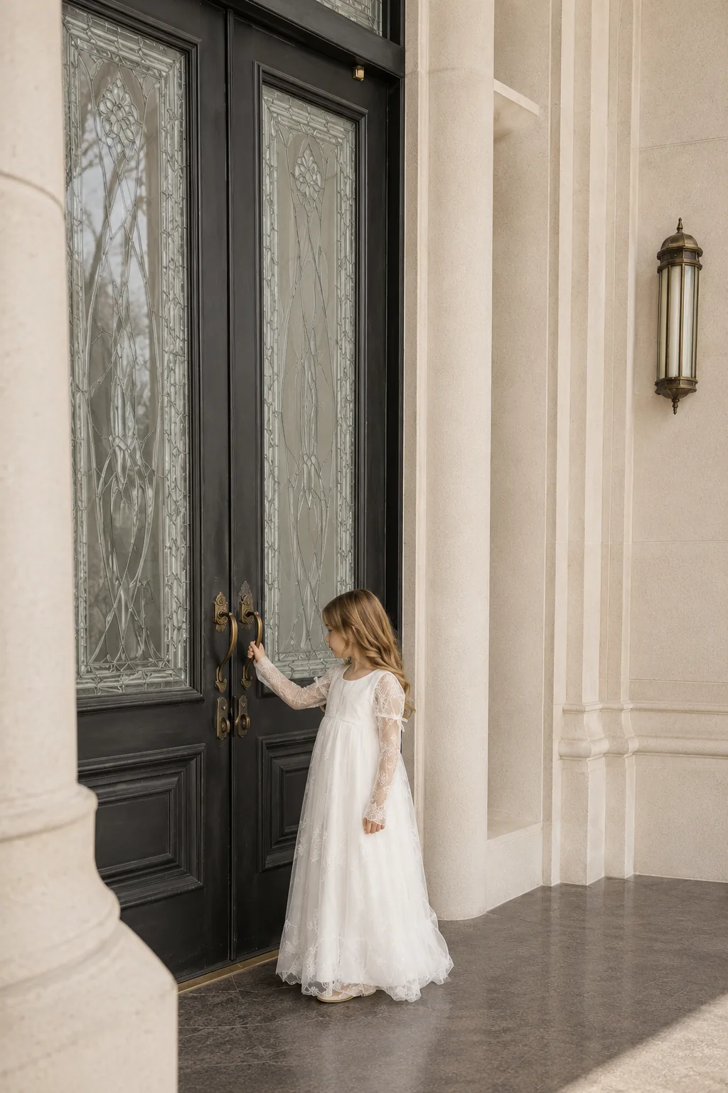 Child in white standing near temple doors